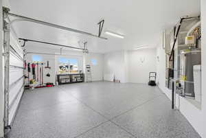 Garage featuring gas water heater and heating unit