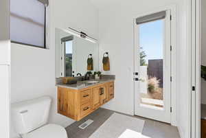 Bathroom with vanity and dark tile patterned flooring