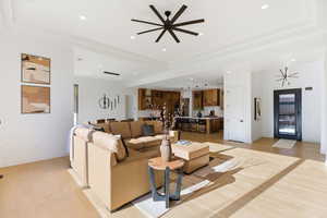 Living area featuring ceiling fan, light wood finished floors, and recessed lighting