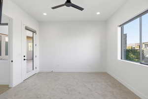 Unfurnished bedroom featuring recessed lighting, light colored carpet, and a ceiling fan