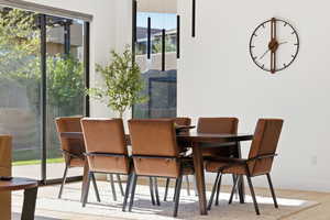 Dining area with light wood-type flooring and baseboards