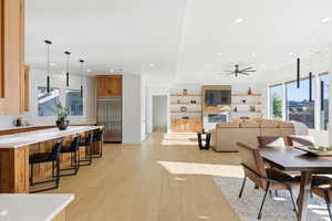 Dining area featuring light wood-style flooring, a ceiling fan, and recessed lighting