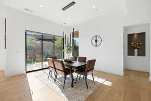 Dining area featuring light wood-style floors and recessed lighting
