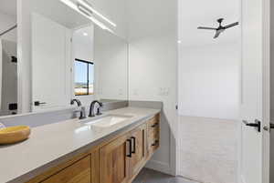 Bathroom featuring vanity, dark carpet, ceiling fan, and recessed lighting