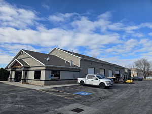 View of property featuring uncovered parking