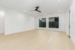 Empty room with light wood-style flooring, recessed lighting, and a ceiling fan