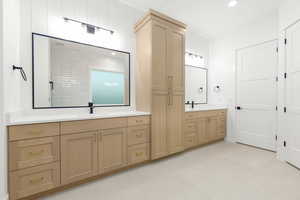 Full bath with two vanities, recessed lighting, and light tile patterned floors