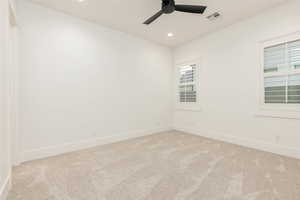 Unfurnished room featuring light colored carpet, recessed lighting, and a ceiling fan