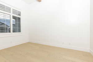 Spare room with light wood-style floors and baseboards