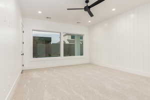 Spare room featuring light carpet, a ceiling fan, and recessed lighting