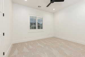 Empty room with light colored carpet, a ceiling fan, and recessed lighting