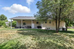 Rear view of house featuring a patio area, a yard, and ceiling fan