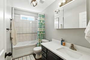 Bathroom featuring vanity and shower / tub combo with curtain