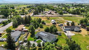 Aerial view of property's location featuring nearby suburban area and mountains