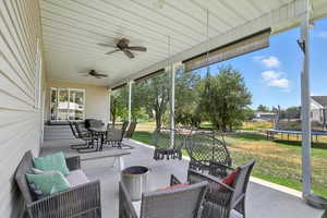 View of patio / terrace featuring outdoor dining area, a trampoline, outdoor lounge area, and ceiling fan