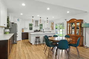 Dining area with light wood-style floors, recessed lighting, and plenty of natural light