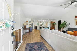Living area featuring recessed lighting, light wood-type flooring, a ceiling fan, and vaulted ceiling
