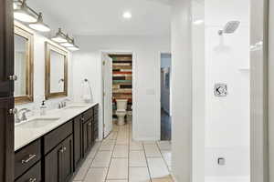 Full bathroom with double vanity and a shower