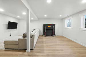 Living room featuring light wood finished floors and recessed lighting