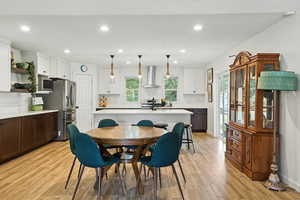 Dining room featuring light wood-style floors and recessed lighting
