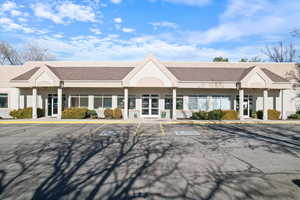 View of property featuring uncovered parking