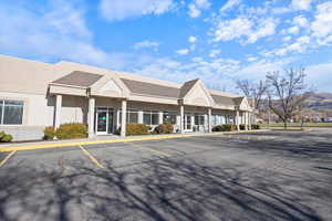 View of property featuring uncovered parking
