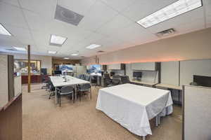 Dining area featuring a drop ceiling and an office area