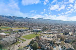 Aerial view of property and surrounding area with a mountain backdrop