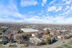 Aerial view of property and surrounding area with a mountainous background