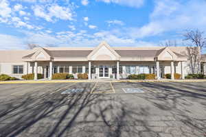 View of property with uncovered parking
