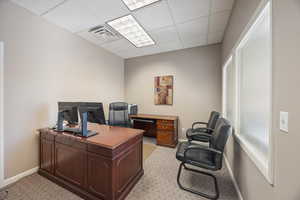 Home office featuring a drop ceiling