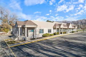 View of property with uncovered parking, a mountain view, and a residential view