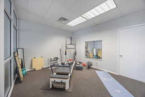 Workout room featuring a paneled ceiling