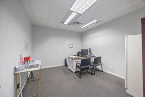 Home office featuring a drop ceiling