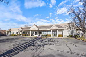 View of property featuring uncovered parking