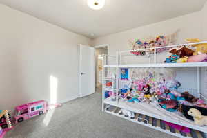 Bedroom with carpet flooring and baseboards