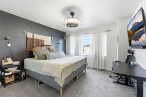 Bedroom featuring light carpet and a textured ceiling