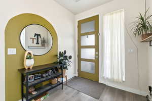 Entryway with wood finished floors and baseboards