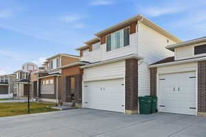 View of front of property featuring a garage and driveway