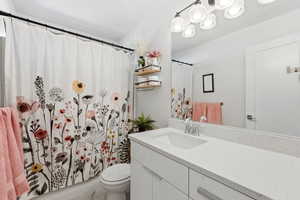 Bathroom featuring vanity and curtained shower
