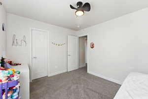 Bedroom with carpet floors and baseboards
