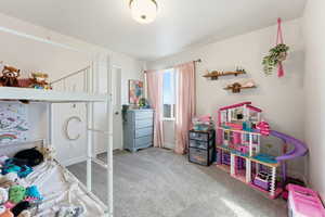 Bedroom featuring carpet flooring and baseboards