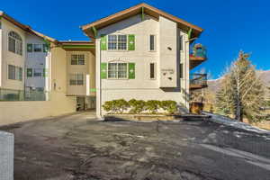 View of property exterior featuring stucco siding and a balcony