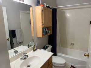 Bathroom with vanity and shower / bath combo with shower curtain