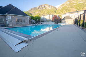 Community pool featuring a patio and a mountain view