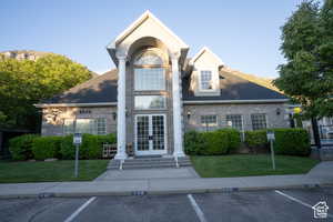 View of building exterior with uncovered parking
