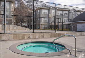 View of swimming pool featuring a community hot tub