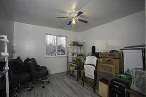 Office featuring a textured ceiling, ceiling fan, and wood tiled floors