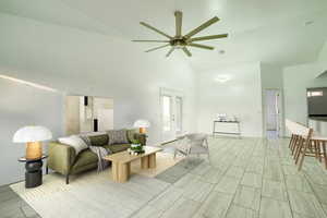 Living area featuring vaulted ceiling and ceiling fan
