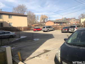 Uncovered parking lot featuring a residential view
